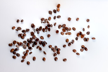 Coffee beans in flight on white background out of focus, blur, made from two photos with copy space.