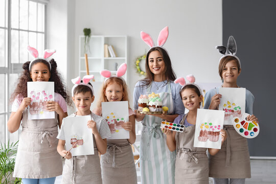 Children and teacher during master-class in art on Easter eve