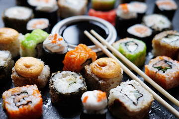 Set of sushi and maki on stone table. © Raisa Kanareva
