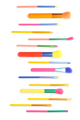 Set of colorful makeup brushes isolated on white, top view