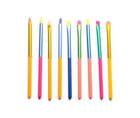 Set of colorful makeup brushes isolated on white, top view