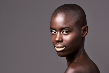 Committed to glamour. Portrait of a beautiful african woman standing in studio.