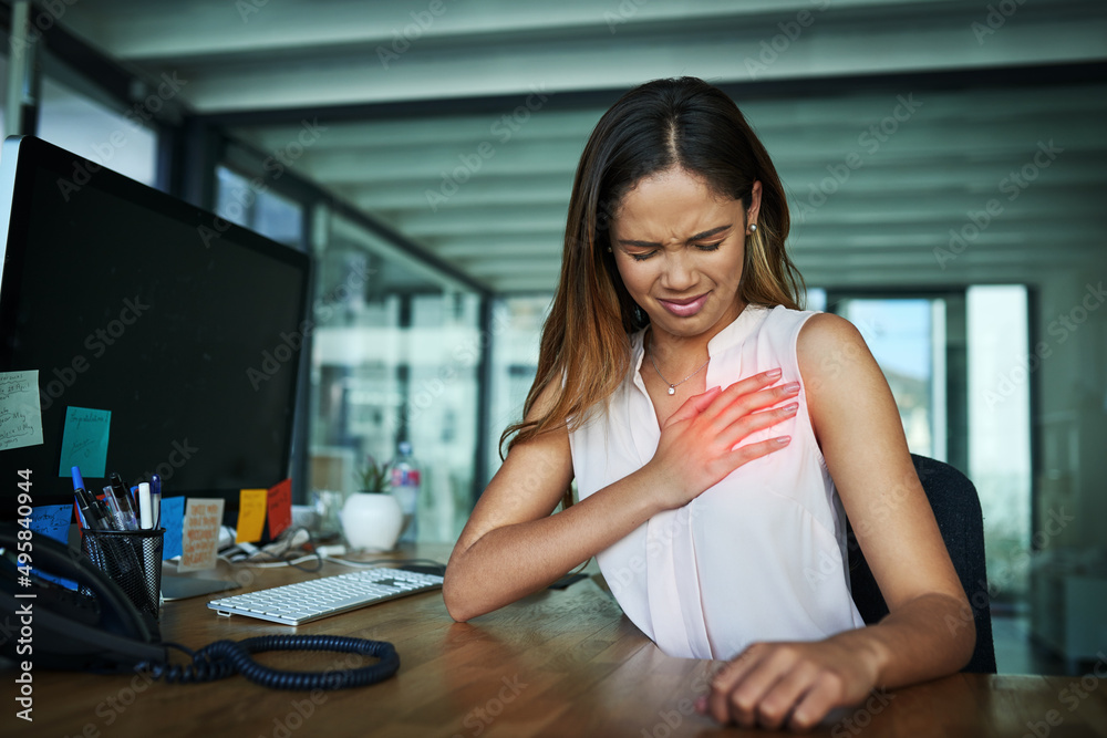 Poster what was that sharp pain. shot of a young businesswoman suffering with chest pain while working in a