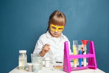 Portrait of kid girl student scientists making experiment in lab