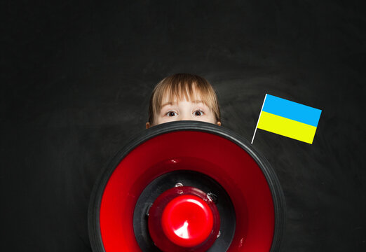Small kid with loudspeaker and Ukrainian flag on black background. No War in Ukraine concept - Powered by Adobe