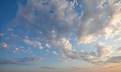 Naklejka na ściany i meble Puffy white clouds in blue sky background