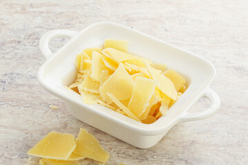 Sliced parmesan cheese heap in the bowl