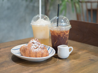 Croissant with ice coffee and lemon juice