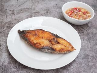 Deep fried Indo-Pacific king mackerels or king mackerels fish with spicy fish sauce 