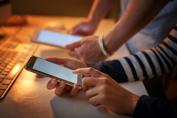 Cracking codes on our touch screens. Shot of unrecognizable computer programmers using different devices in the office.