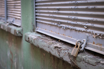 Closed shop shutter and padlock. Economic crises and bankruptcies.