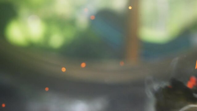 Close up of a smoking and glowing sage smudge stick, cleansing the air