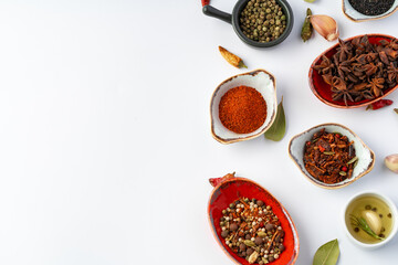 Bowls with various spices on white background
