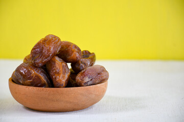 Big dates isolated. Dry date fruits heap, medjool, medjoul or majhool, royal dates side view on white background