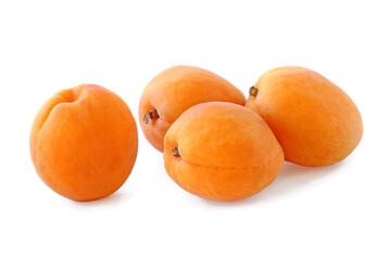 Several big flat ripe apricots isolated on white background