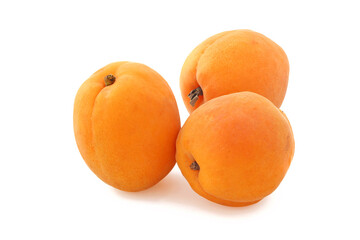 Three big flat ripe apricots  isolated on white background