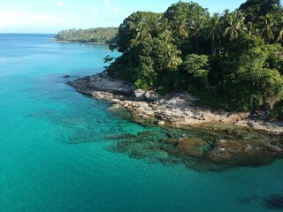 At Sea Island.Aerial view. Top view.amazing nature background.The color of the water and beautifully bright.Azure beach with rocky mountains and clear water of Thailand ocean at sunny day