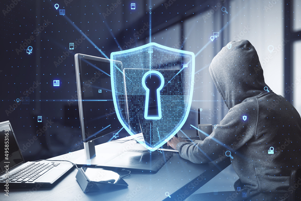Aufkleber Side view of hacker at desktop using computers with creative glowing web security shield on blurry office interior background. Secure information concept. Double exposure.