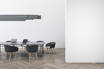 Luxury concrete and wooden meeting room interior with empty mock up place on wall, furniture, ceiling lamp and laptop device on table. Workplace and conference concept. 3D Rendering.