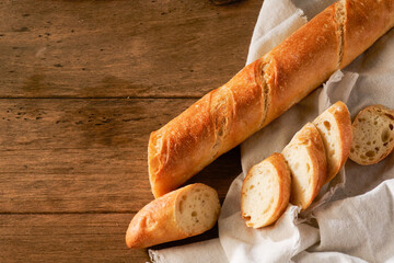 fresh homemade baguette on a wooden background