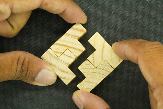 The puzzles are arranged and the hand holds the last Puzzle for combination