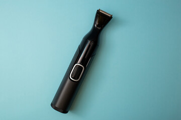 Electric shaver with attachments on a blue background