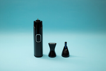 Electric shaver with attachments on a blue background