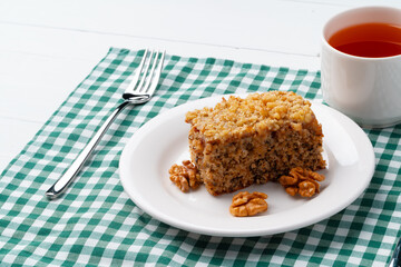 Piece of nut cake on white plate