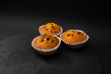 Juicy cupcakes on a black background, confectionery, bakery