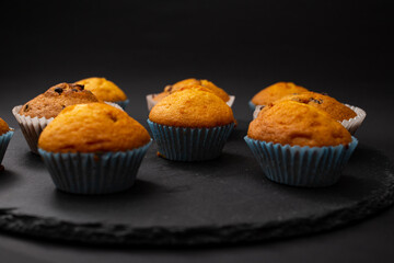 Juicy cupcakes on a black background, confectionery, bakery