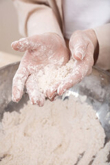 Women's hands kneading dough for baking