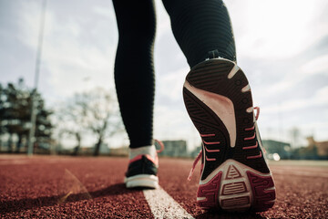Plakat Sport runner girl training. Run woman workout exercise. Runner feet running on road closeup on shoe. Fitness, sport, lifestyle concept.