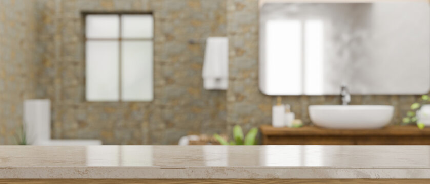 Empty space on marble bathroom countertop over blurred modern stone bathroom