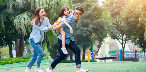 Image of young Asian family playing together at park - Powered by Adobe
