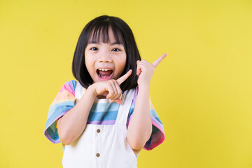 Portrait of Asian child on yellow background