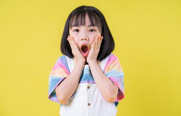 Portrait of Asian child on yellow background