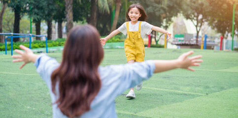 Asian mother and daughter playing together at park