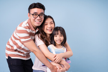 Portrait of young Asian family on background