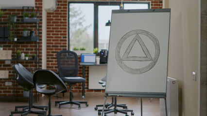 Close up of aa meeting symbol on white board in counseling office. Concept of anonymous alcoholics...