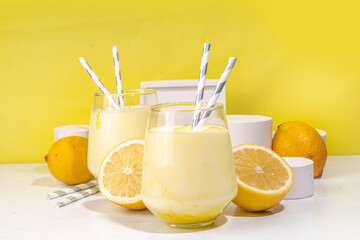 Creamy lemon fruit smoothie, yogurt ar milkshake, Sour sweet drink with fresh lemons on white...