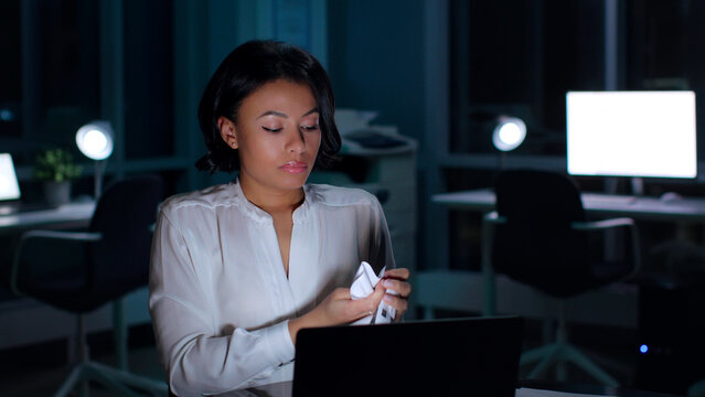 African-American businesswoman crumple document working late in office