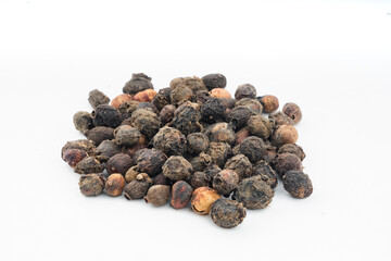Dried Brown Jamun Gutli(Indian Blackberry Kernels) over isolated white closeup Spreaded