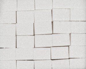 Naklejka premium Natural white sugar cubes texture background