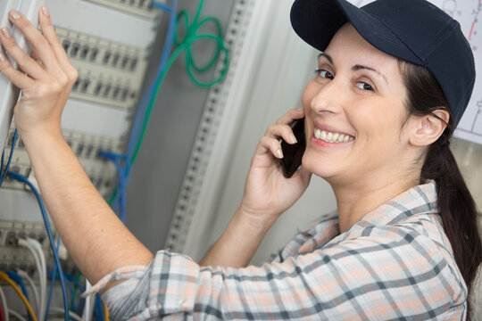 Female Electrician Working On A Electrical Board