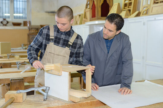 portrait of a man and apprentice in carpentry class