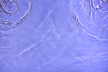 Transparent purple water surface texture with ripples, splashes and bubbles. Abstract nature...