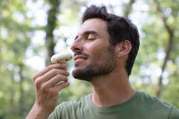 man smelling a truffle mushrooms