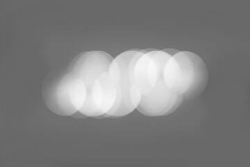 Abstract light bubble out-focus effect in grey background.