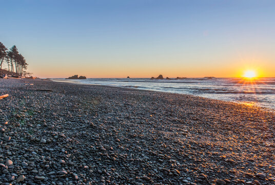 Ruby Beach in Olympic National Park with sun setting over ocean.