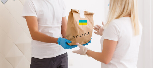 a man holds a box with humanitarian aid to ukraine